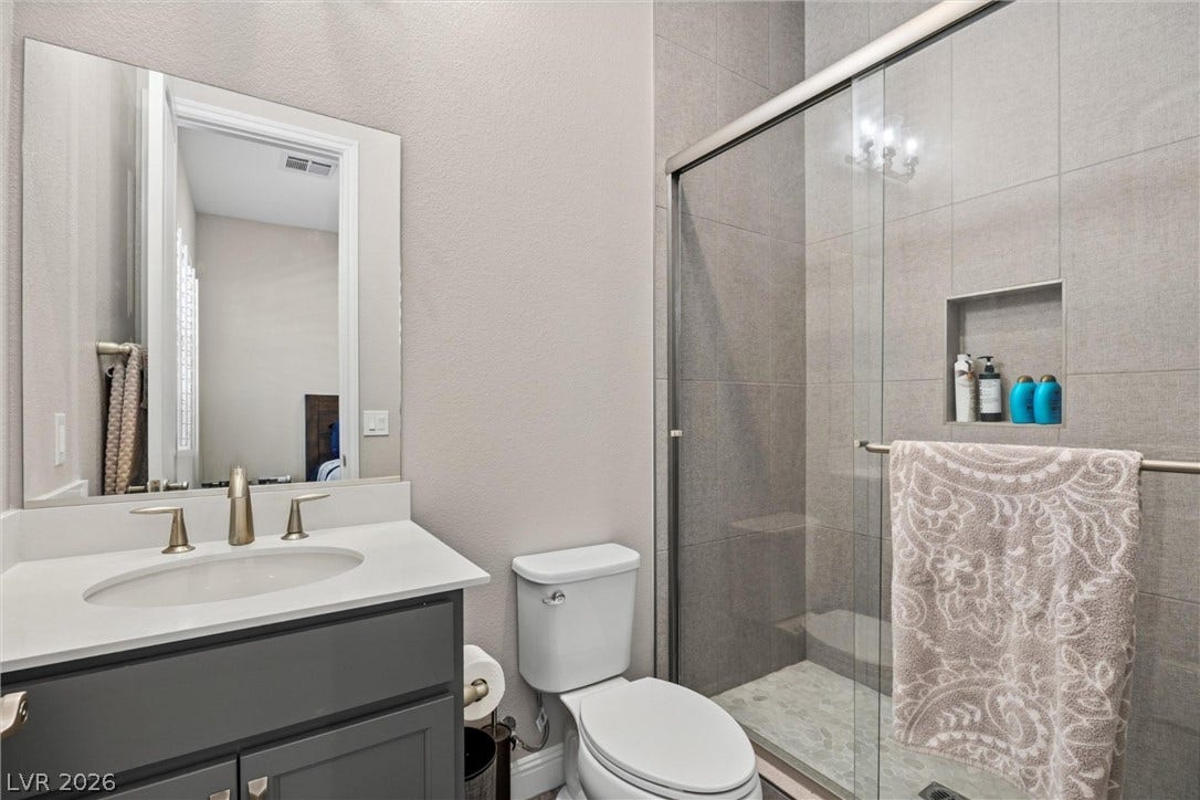 3382 Spring Rock Avenue, Henderson, NV 89044 Clean lines and modern tile highlight this well-appointed bathroom with a glass-enclosed shower.