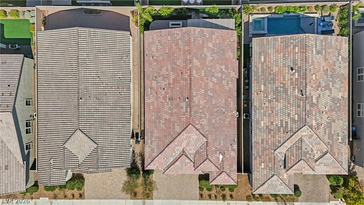 3382 Spring Rock Avenue, Henderson, NV 89044 An aerial perspective showcases the tiled rooftops and structured layouts of neighboring properties.