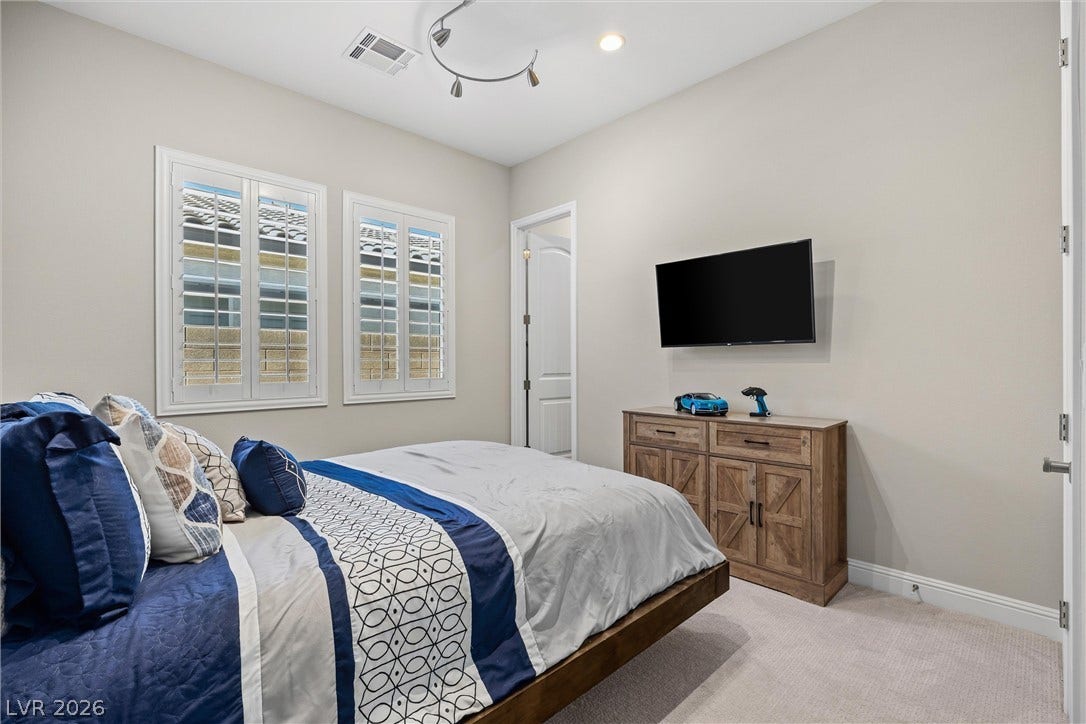 3382 Spring Rock Avenue, Henderson, NV 89044 Classic plantation shutters and neutral carpeting define this comfortable secondary bedroom.