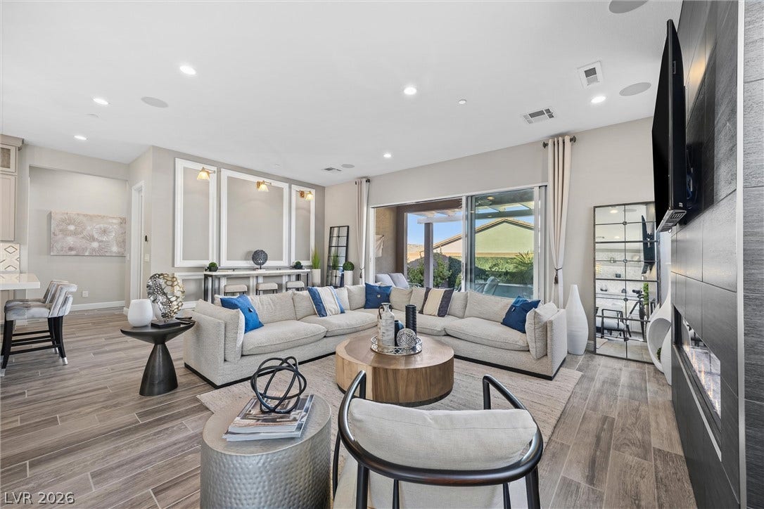 3382 Spring Rock Avenue, Henderson, NV 89044 Gleaming wood-look tile floors and recessed lighting enhance this expansive open-concept living area.