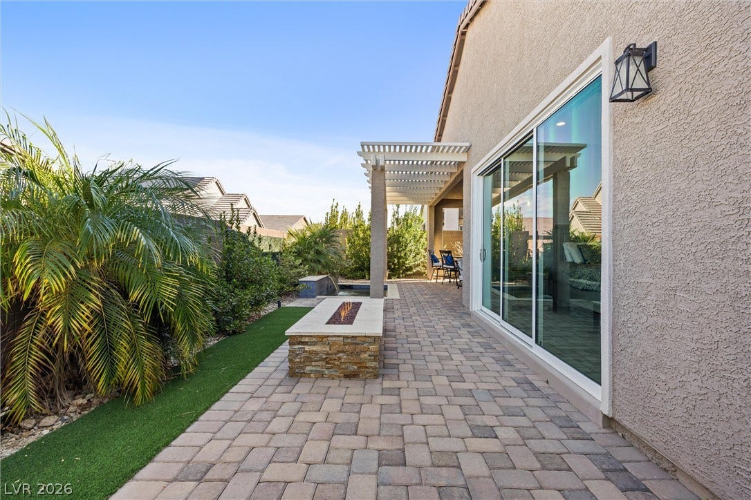 3382 Spring Rock Avenue, Henderson, NV 89044 Large sliding glass doors open directly to a beautifully paved patio with a built-in fire pit.