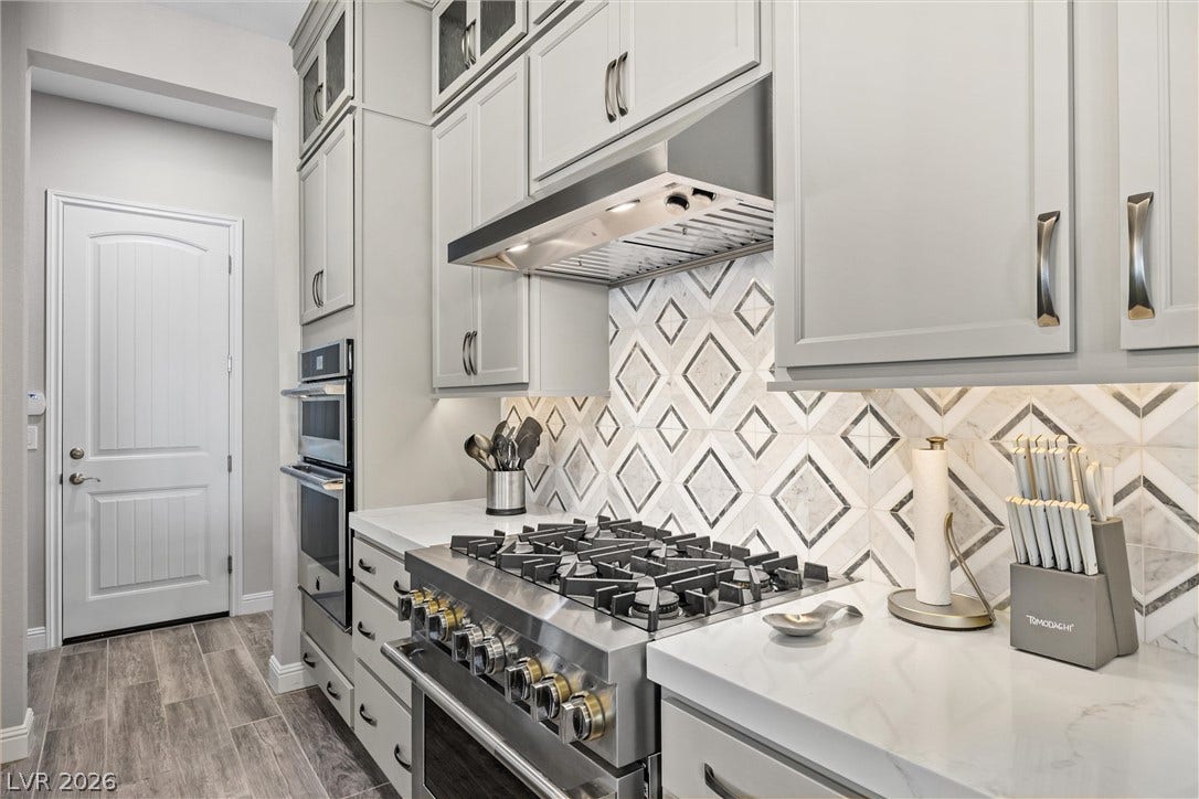 3382 Spring Rock Avenue, Henderson, NV 89044 Premium cooking appliances and patterned tile backsplash enhance this modern culinary space.