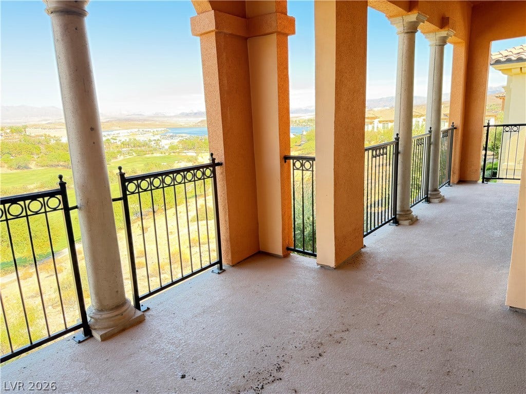 12 Via Visione, #204, Henderson, NV 89011 Sweeping water and golf course vistas unfold from this covered upper-level balcony with elegant columns.