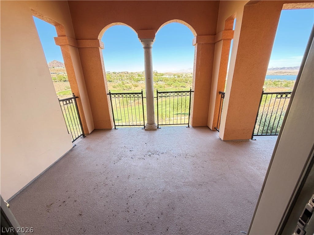 12 Via Visione, #204, Henderson, NV 89011 Stately arched openings frame sweeping views of the surrounding hills, golf course, and water.