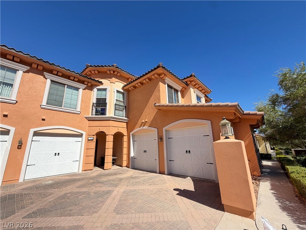 12 Via Visione, #204, Henderson, NV 89011 Spanish tile roofing and warm stucco finishes define this multi-level exterior architecture.