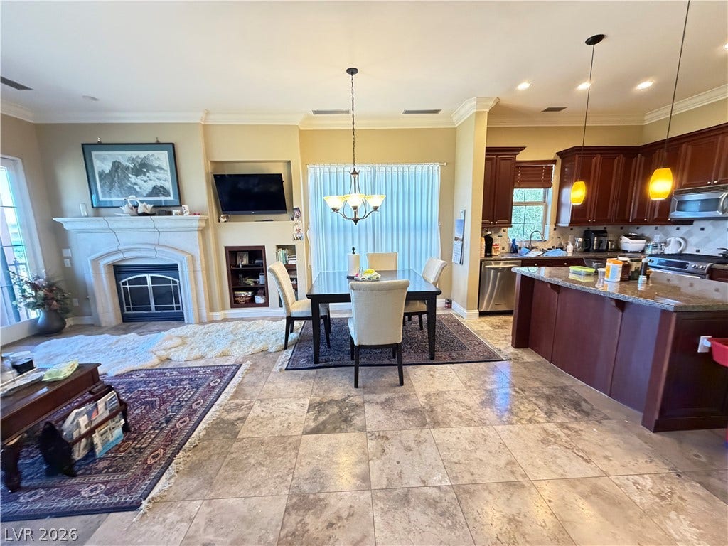 12 Via Visione, #204, Henderson, NV 89011 Granite counters and tile floors enrich this open-plan design centered around a fireplace.