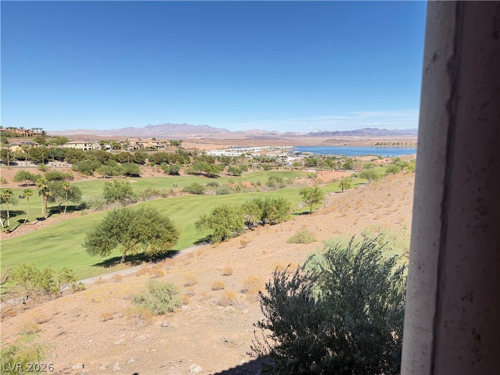 12 Via Visione, #204, Henderson, NV 89011 Sweeping panoramas overlook the verdant golf course and distant water under clear desert skies.