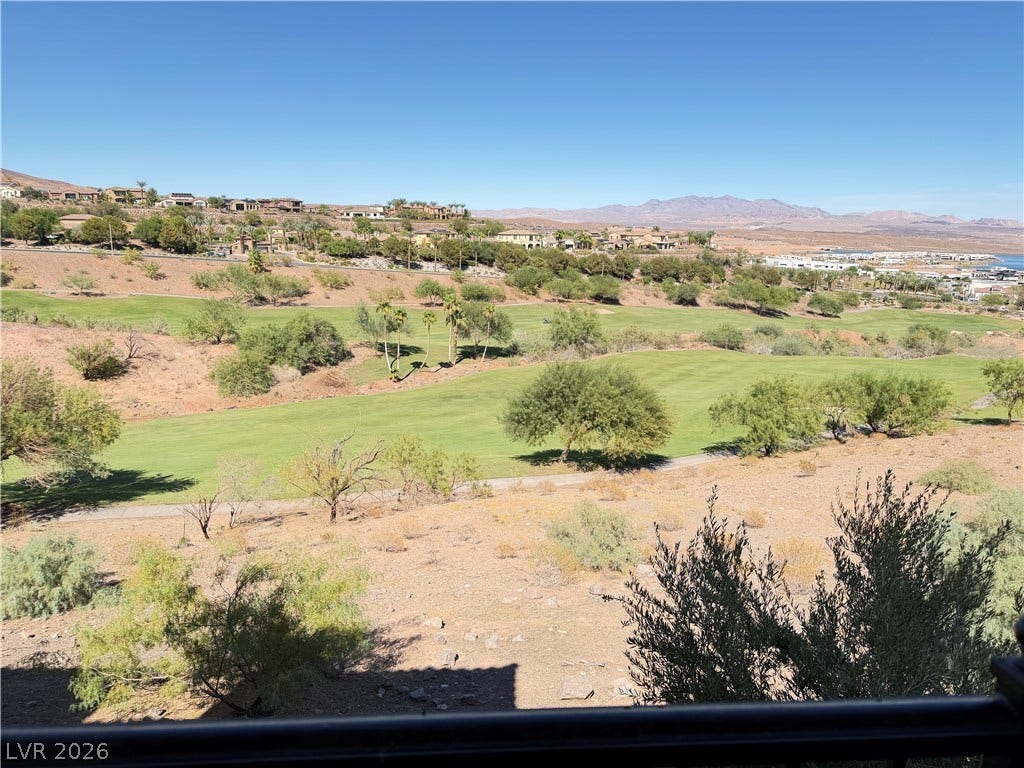 12 Via Visione, #204, Henderson, NV 89011 Sweeping mountain and desert golf course vistas stretch out under a clear blue sky.