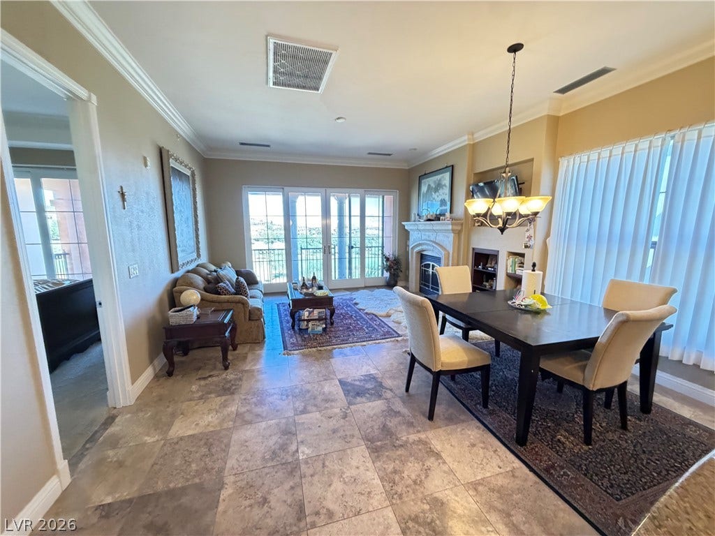 12 Via Visione, #204, Henderson, NV 89011 Crown molding highlights the ceiling of this open space connecting a dining area and living room.