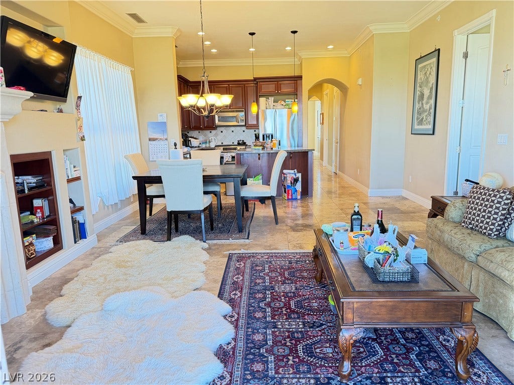12 Via Visione, #204, Henderson, NV 89011 Gleaming tile floors and custom built-ins define this airy, open-concept living and dining layout.
