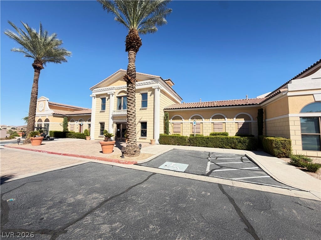 12 Via Visione, #204, Henderson, NV 89011 Stately classical columns and grand architecture define this impressive Mediterranean-style exterior under clear blue skies.