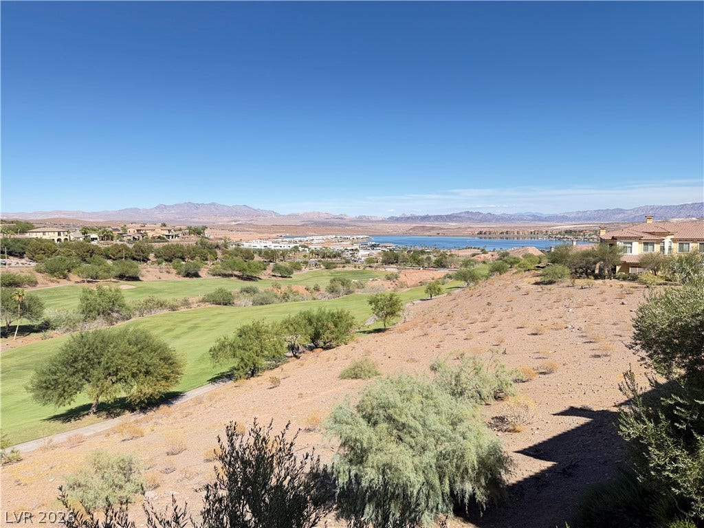 12 Via Visione, #204, Henderson, NV 89011 Panoramas of the emerald golf course fairway unfold against a desert mountain backdrop.