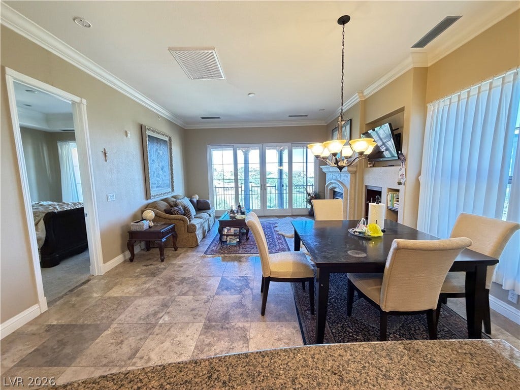 12 Via Visione, #204, Henderson, NV 89011 Gleaming tile floors and detailed crown molding elevate this open-concept main living space.
