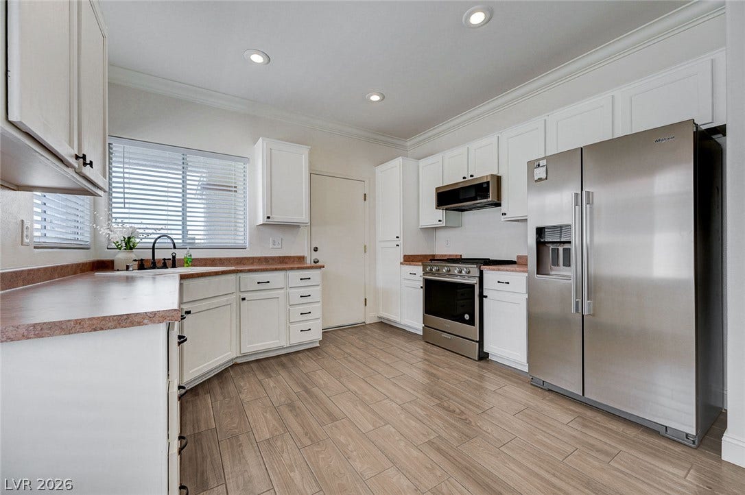 2851 Sapphire Desert Drive, Henderson, NV 89052 Gleaming tile floors and custom cabinetry define this thoughtfully designed modern kitchen.