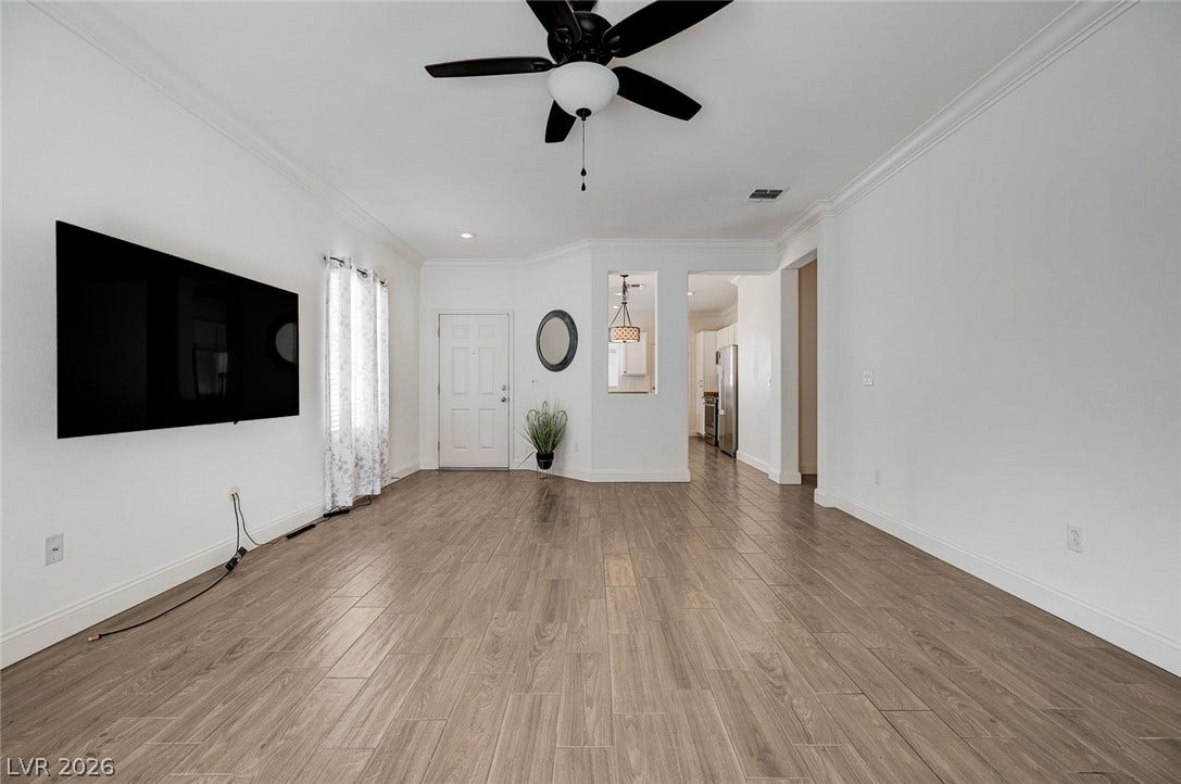 2851 Sapphire Desert Drive, Henderson, NV 89052 Plank flooring and detailed crown molding enhance this airy, open interior layout.