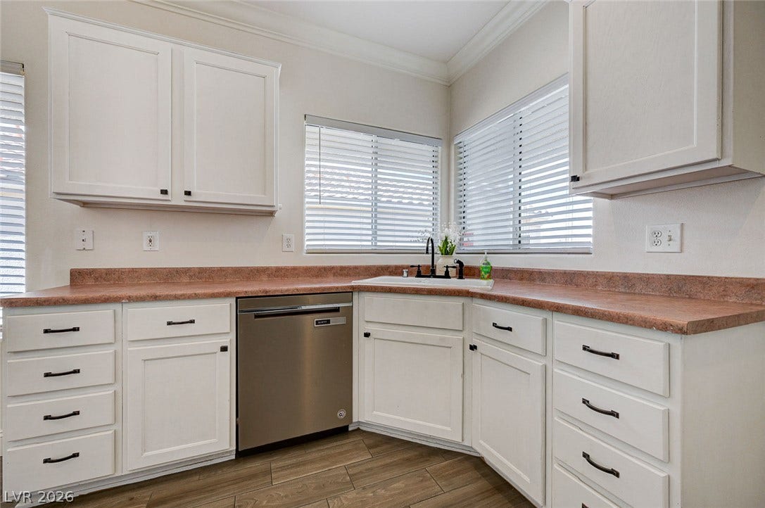 2851 Sapphire Desert Drive, Henderson, NV 89052 Ample cabinetry and durable wood-look tile flooring anchor this functional culinary workspace.