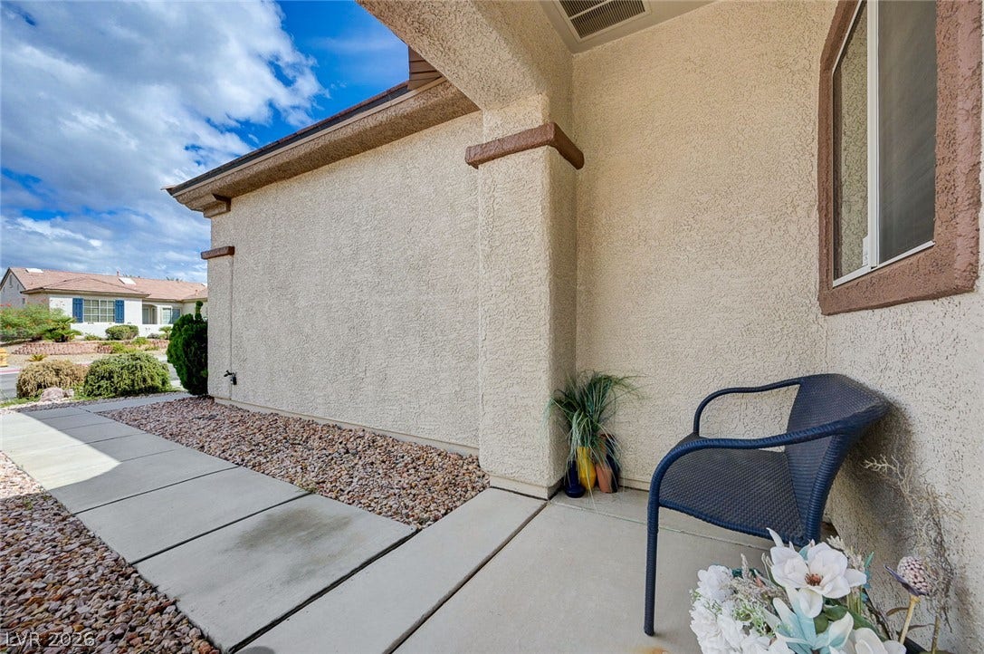 2851 Sapphire Desert Drive, Henderson, NV 89052 A welcoming covered entrance features a concrete walkway bordered by neat gravel landscaping.