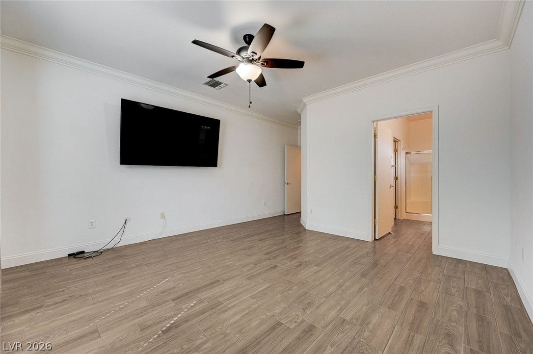 2851 Sapphire Desert Drive, Henderson, NV 89052 Polished crown molding and rich plank flooring define this versatile interior space.