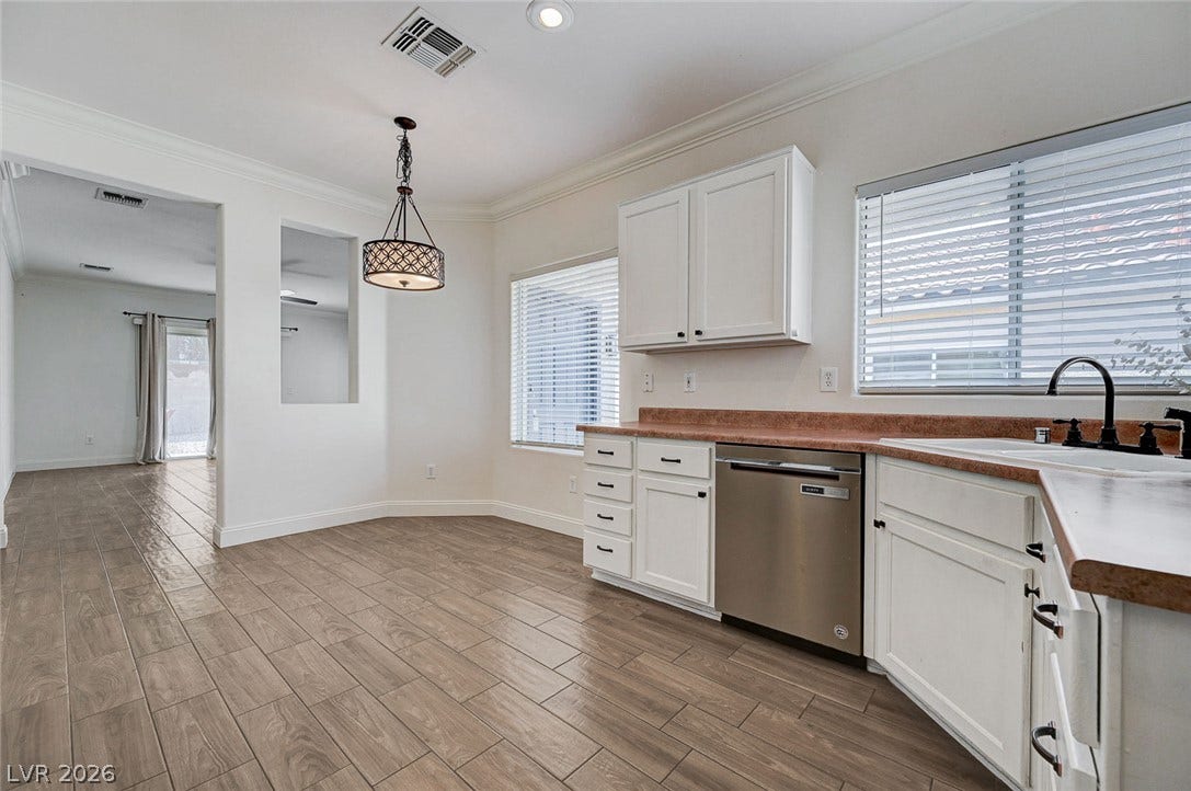 2851 Sapphire Desert Drive, Henderson, NV 89052 An open kitchen layout flows seamlessly into adjacent living spaces over wood-look tile flooring.
