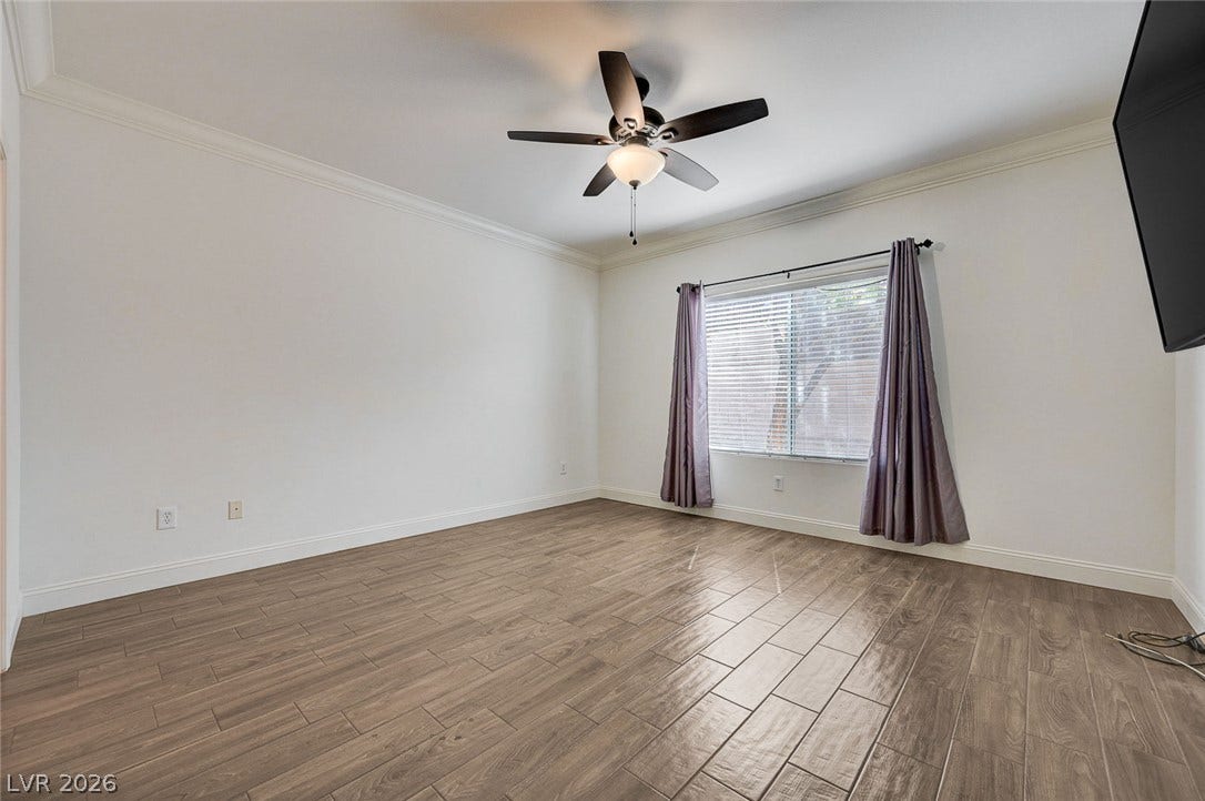 2851 Sapphire Desert Drive, Henderson, NV 89052 Elegant crown molding complements the wood-look tile flooring in this versatile living space.