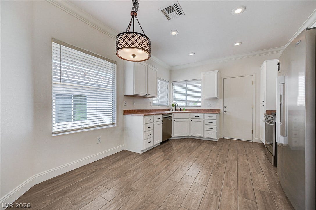 2851 Sapphire Desert Drive, Henderson, NV 89052 Gleaming wood-look tile floors complement the classic cabinetry in this airy kitchen.