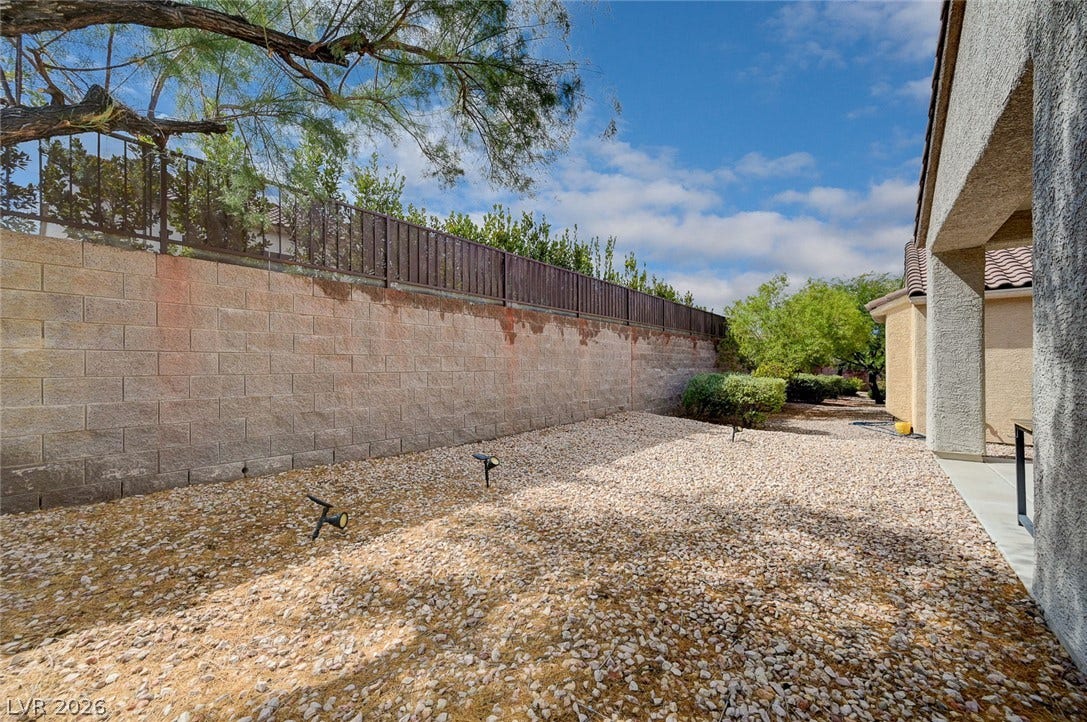 2851 Sapphire Desert Drive, Henderson, NV 89052 Low-maintenance gravel landscaping lines the side yard bordered by a sturdy privacy wall.