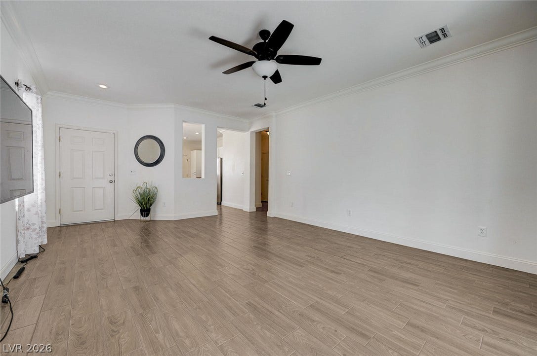2851 Sapphire Desert Drive, Henderson, NV 89052 Elegant crown molding complements the sleek wood-look flooring flowing throughout this open living space.