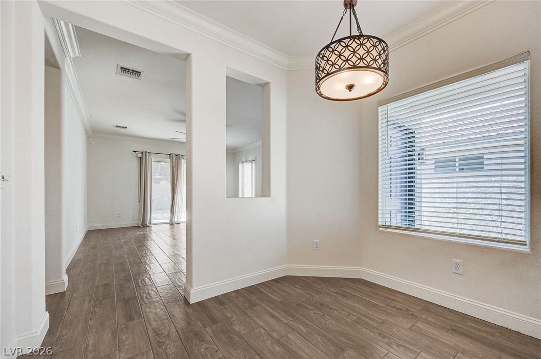 2851 Sapphire Desert Drive, Henderson, NV 89052 Gleaming wood-look tile floors and elegant crown molding flow through the open-concept layout.