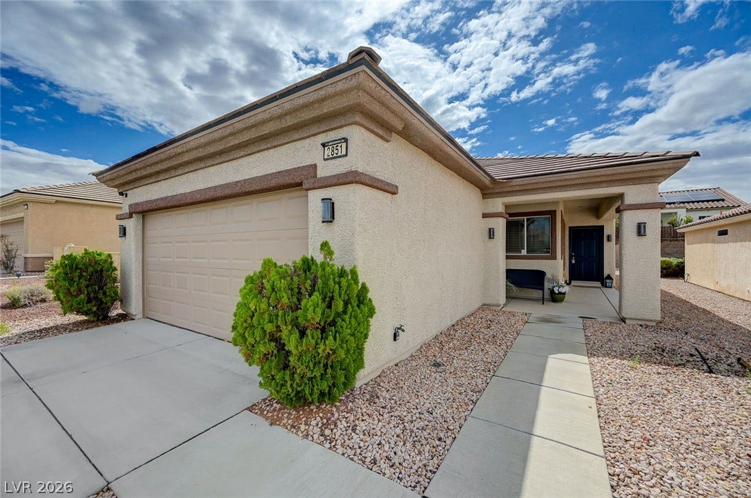 2851 Sapphire Desert Drive, Henderson, NV 89052 Crisp desert landscaping and a stucco exterior frame this modern single-story residence.
