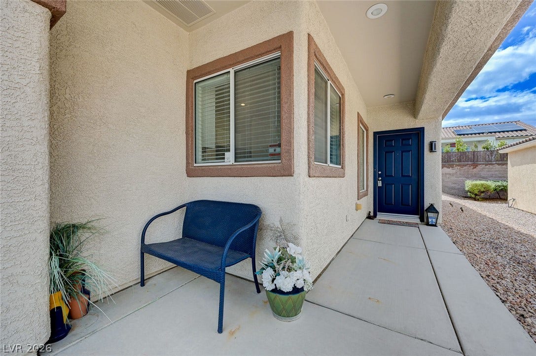 2851 Sapphire Desert Drive, Henderson, NV 89052 A welcoming front porch features smooth concrete flooring and classic stucco exterior walls.