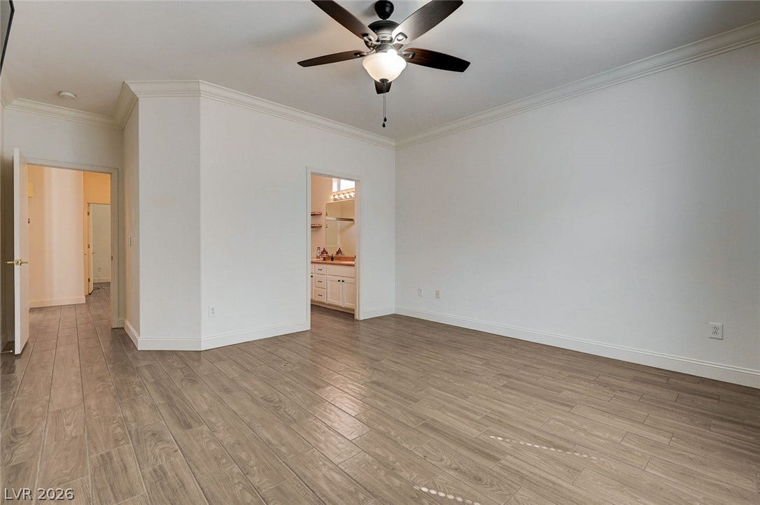 2851 Sapphire Desert Drive, Henderson, NV 89052 Elegant crown molding complements the sleek wood-look flooring and clean architectural lines.