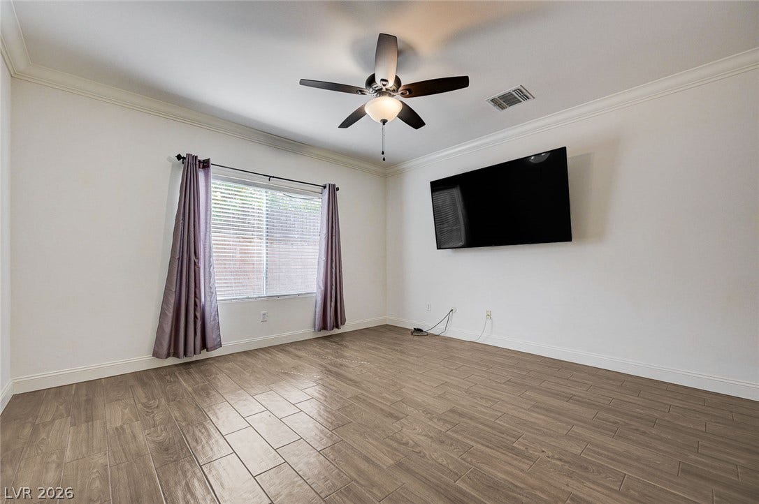 2851 Sapphire Desert Drive, Henderson, NV 89052 Polished tile flooring and classic crown molding elevate this versatile interior space.