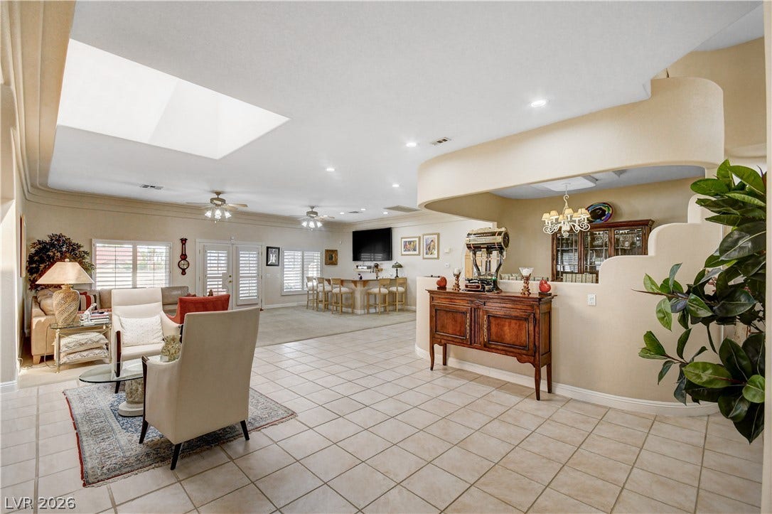 2000 Alexa Breanne Court, Las Vegas, NV 89117 An open floorplan unites tiled living areas beneath a soaring skylight and smooth architectural arches.