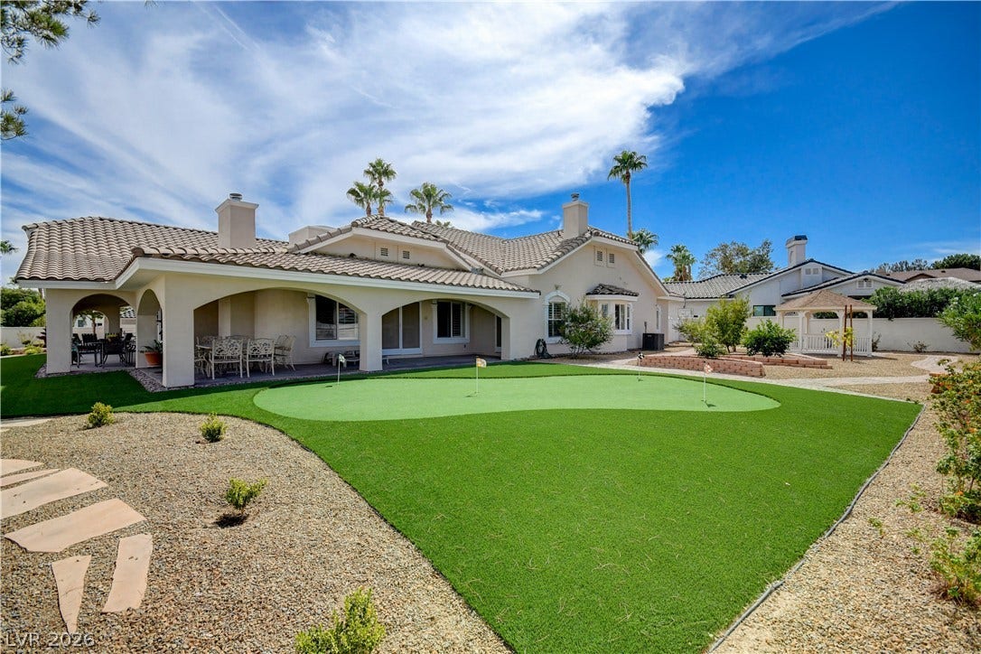2000 Alexa Breanne Court, Las Vegas, NV 89117 A private putting green highlights this beautifully landscaped backyard under a clear blue sky.