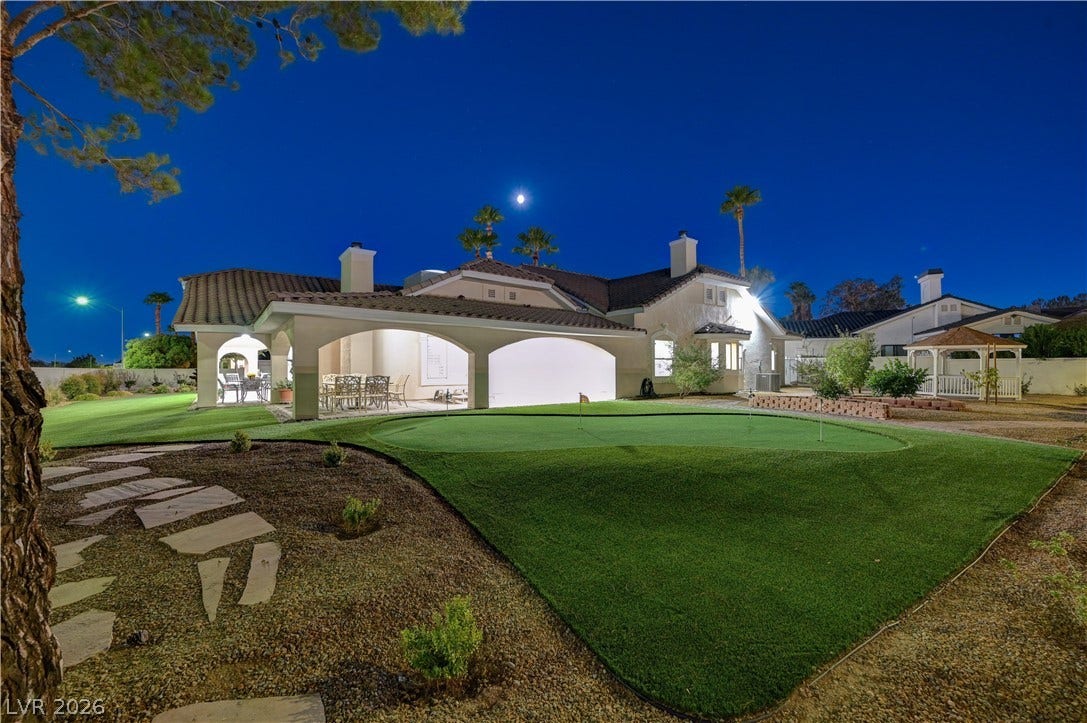 2000 Alexa Breanne Court, Las Vegas, NV 89117 An immaculate putting green highlights this expansive rear yard under a twilight sky.