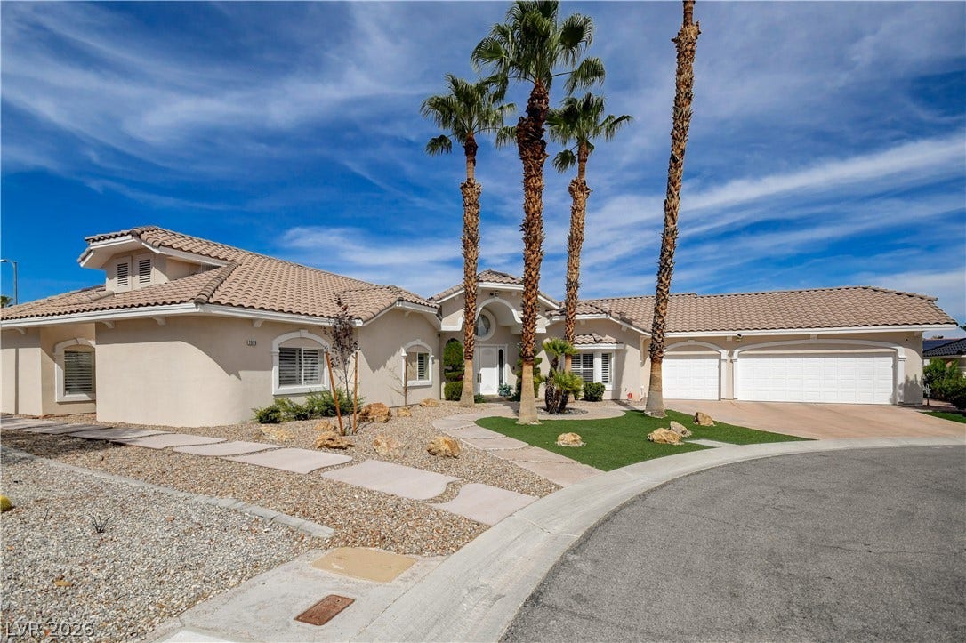 2000 Alexa Breanne Court, Las Vegas, NV 89117 Manicured desert landscaping and towering palm trees frame this elegant tile-roofed residence.