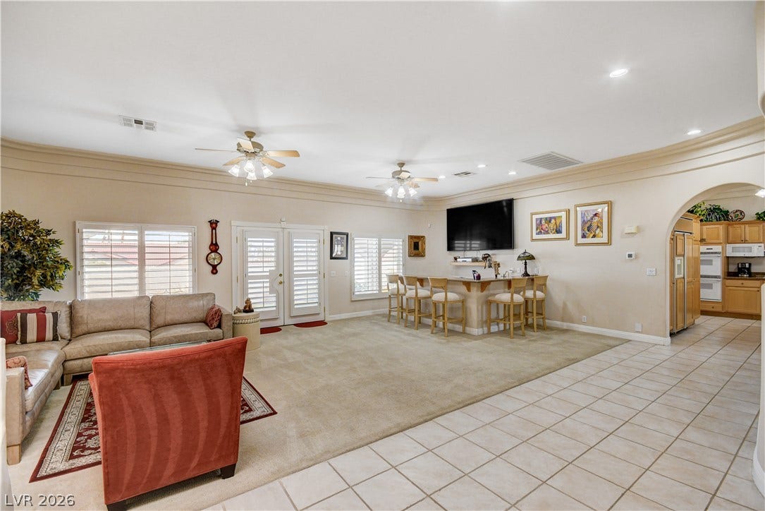 2000 Alexa Breanne Court, Las Vegas, NV 89117 An open floorplan seamlessly connects the carpeted living area to the tiled walkway and kitchen.
