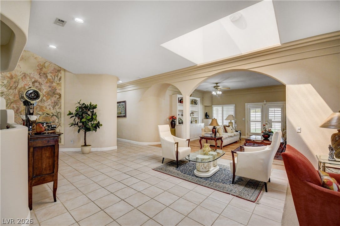 2000 Alexa Breanne Court, Las Vegas, NV 89117 An open floorplan flows seamlessly under architectural arches and a large central skylight.