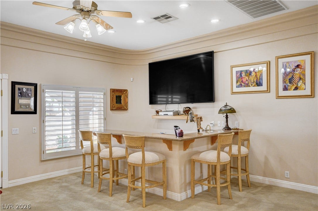 2000 Alexa Breanne Court, Las Vegas, NV 89117 An inviting built-in wet bar stands beneath elegant crown molding and recessed lighting.