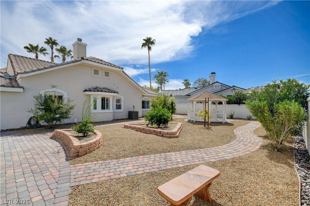 2000 Alexa Breanne Court, Las Vegas, NV 89117 An inviting backyard features a curved paver path leading to a white gazebo.