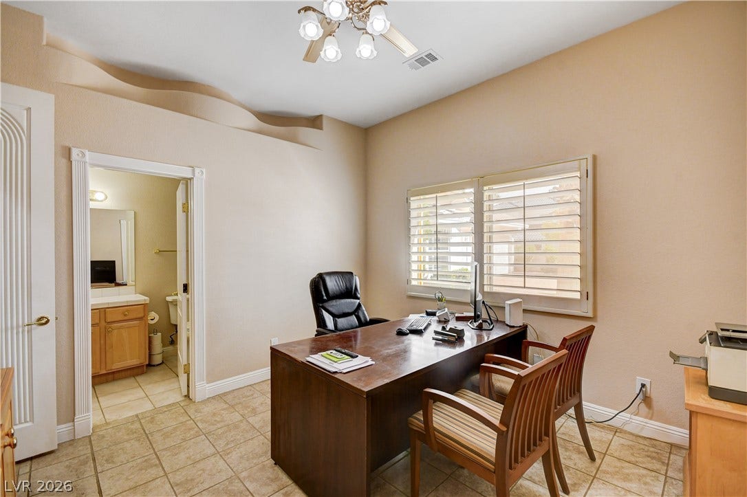 2000 Alexa Breanne Court, Las Vegas, NV 89117 Tiled flooring and architectural wall detailing highlight this functional home workspace.