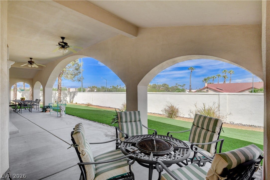 2000 Alexa Breanne Court, Las Vegas, NV 89117 A spacious covered patio features sweeping arches overlooking a tidy backyard with artificial turf.