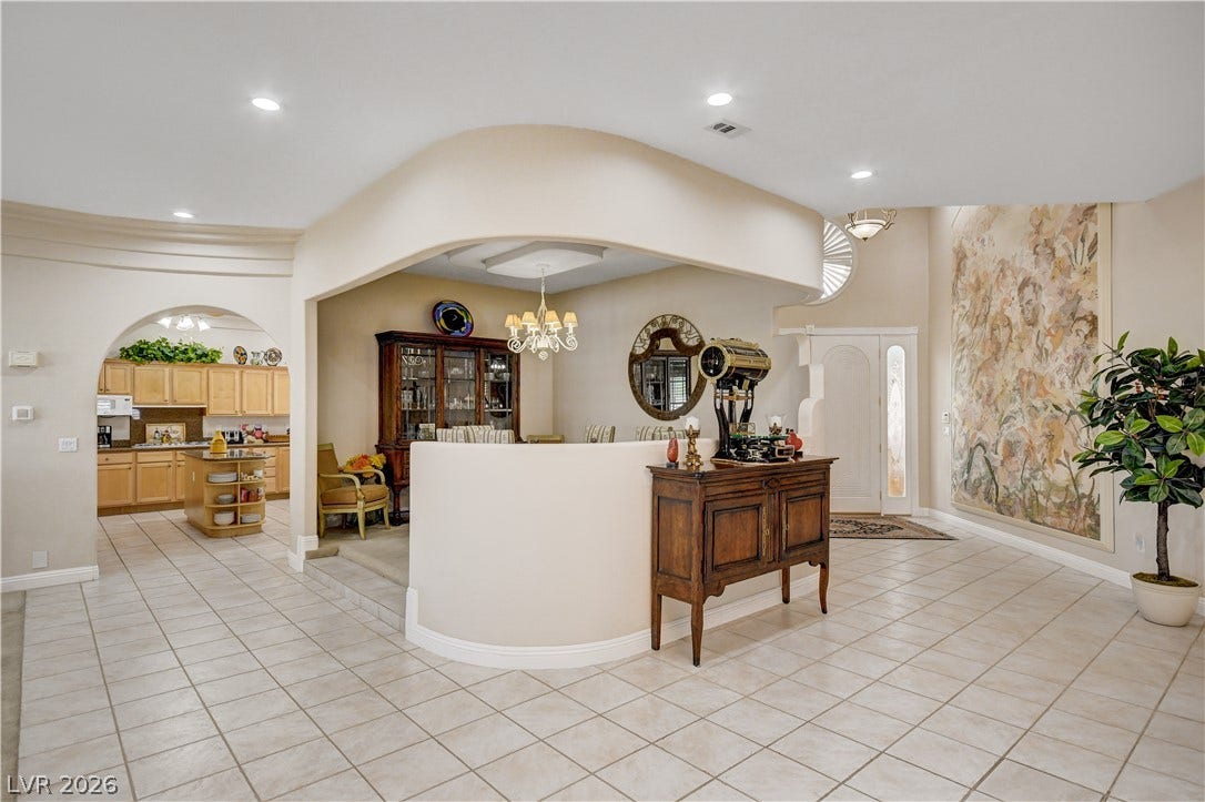 2000 Alexa Breanne Court, Las Vegas, NV 89117 Flowing tile floors guide the eye past arched entryways into a spacious open layout.