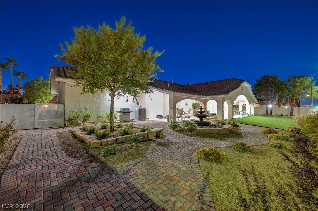 2000 Alexa Breanne Court, Las Vegas, NV 89117 Inviting brick paver pathways wind through the meticulously landscaped backyard featuring a tiered stone fountain.