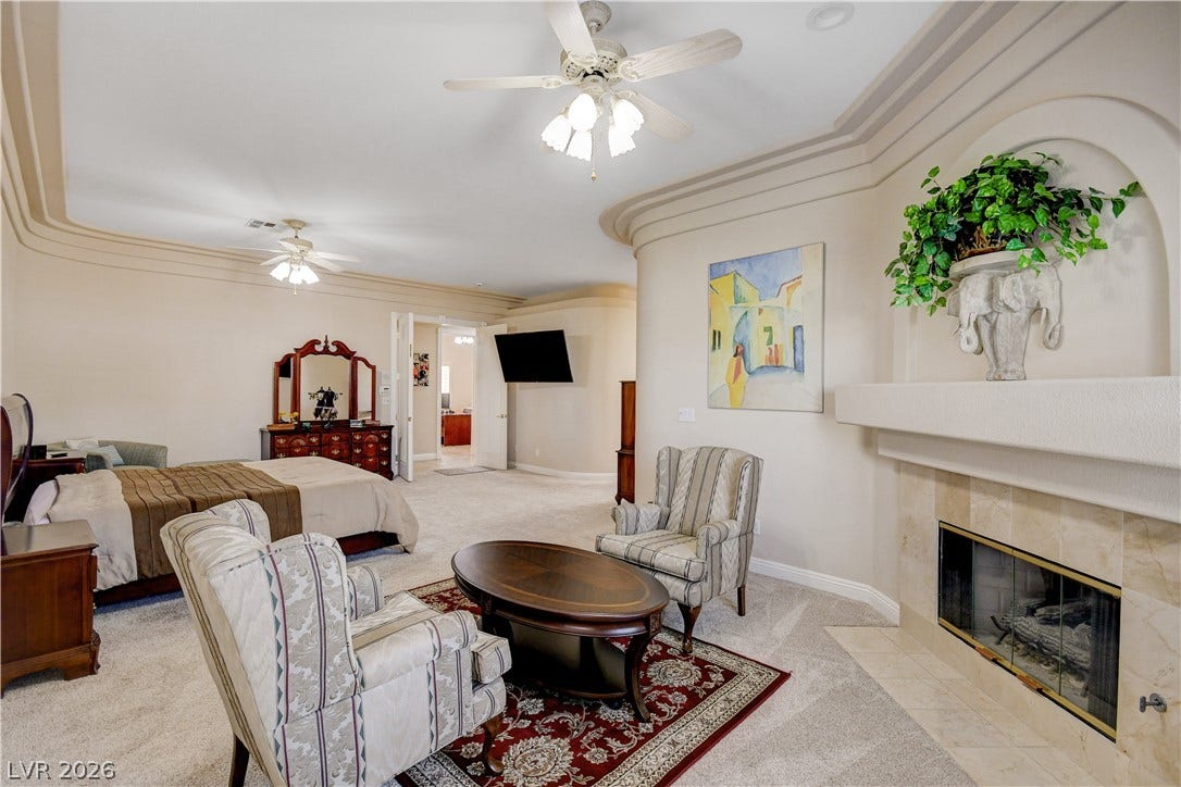 2000 Alexa Breanne Court, Las Vegas, NV 89117 Elegant crown molding and a classic fireplace with tile surround elevate this comfortable suite.