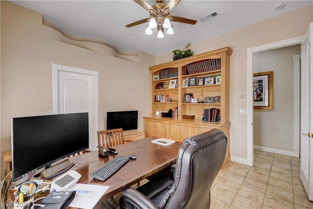 2000 Alexa Breanne Court, Las Vegas, NV 89117 Tiled flooring and custom built-in shelving define this versatile home workspace.