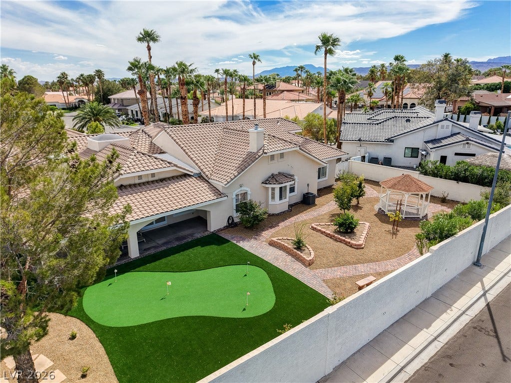2000 Alexa Breanne Court, Las Vegas, NV 89117 An aerial view showcases a putting green and structured pathways within the enclosed backyard.