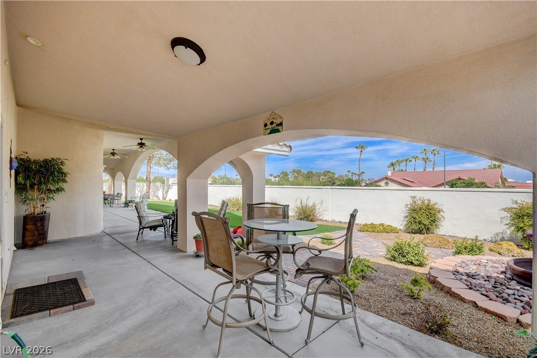 2000 Alexa Breanne Court, Las Vegas, NV 89117 A spacious covered patio features sweeping arched openings overlooking a landscaped backyard.