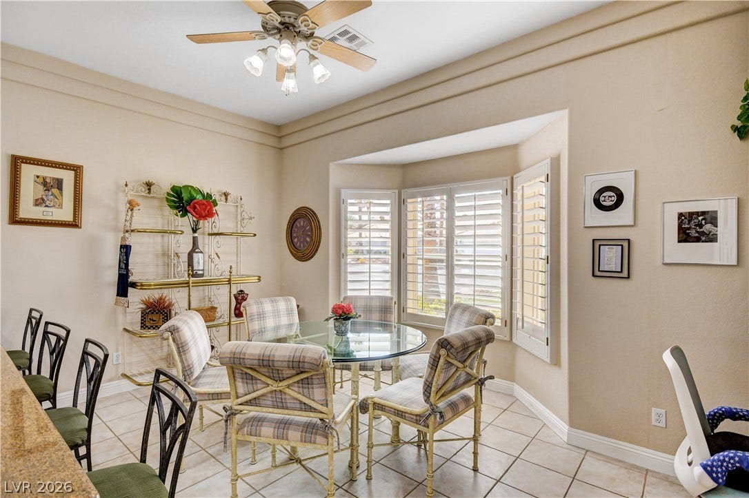 2000 Alexa Breanne Court, Las Vegas, NV 89117 An inviting dining area features crown molding, tile flooring, and a sunlit bay window.