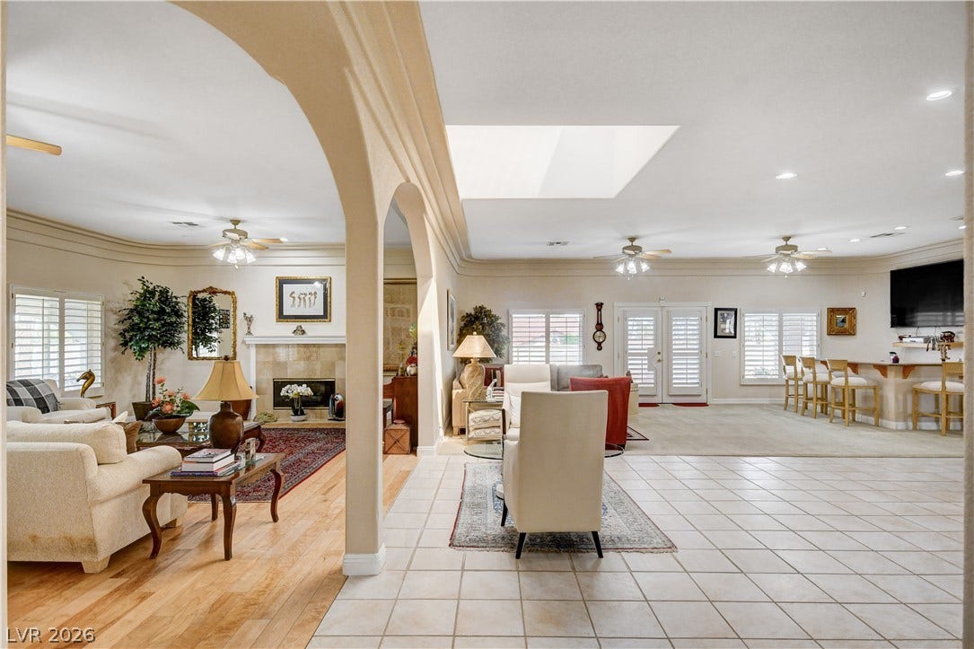 2000 Alexa Breanne Court, Las Vegas, NV 89117 Graceful archways frame an expansive living area complete with a tiled floor and classic fireplace.